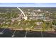 Aerial view of waterfront property, showing proximity to the bay, docks, and lush surroundings at 950 Broadway # 103, Dunedin, FL 34698