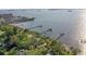 Scenic aerial view of the waterfront property highlighting lush greenery, docks, and bay views at 950 Broadway # 103, Dunedin, FL 34698