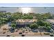 Aerial view of the condominium complex featuring lush landscaping and stunning views of the bay at 950 Broadway # 103, Dunedin, FL 34698