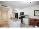 Bright kitchen features granite countertops, white cabinets, and black appliances at 950 Broadway # 103, Dunedin, FL 34698