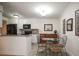 Open concept kitchen featuring granite countertops, modern appliances, and a dining area at 950 Broadway # 103, Dunedin, FL 34698