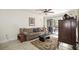 Cozy living room with comfortable seating, area rug, ceiling fan and sliding glass door to outdoor area at 950 Broadway # 103, Dunedin, FL 34698
