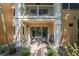Private outdoor patio featuring a table, chairs, colorful outdoor rug, and sliding glass doors at 950 Broadway # 103, Dunedin, FL 34698