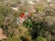 Aerial view of a property in a residential area surrounded by dense trees and lush greenery at 9810 Parsons St, Tampa, FL 33615