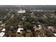 An aerial perspective of a residential neighborhood with homes surrounded by lush greenery at 9810 Parsons St, Tampa, FL 33615