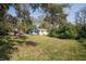 Lush backyard showcasing mature trees, potential for gardening, and outdoor recreation at 9810 Parsons St, Tampa, FL 33615
