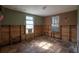 Bedroom with damaged walls and hardwood floor requiring renovation and personalization at 9810 Parsons St, Tampa, FL 33615