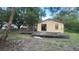 Exterior view of the house with a wooden deck and sliding glass door to the house at 9810 Parsons St, Tampa, FL 33615