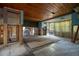Open living room with wood ceiling, tile floors, and natural light, ready for renovation and personalization at 9810 Parsons St, Tampa, FL 33615