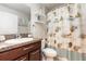 Bathroom features a vanity with granite counter top and a shower-tub combo with decorative shower curtain at 10036 Crested Fringe Dr, Riverview, FL 33578