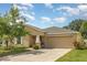 Well-maintained single-Gathering home with a two-car garage, manicured lawn, and a welcoming entrance at 10036 Crested Fringe Dr, Riverview, FL 33578