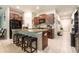 Modern kitchen featuring a breakfast bar, stainless steel appliances, and ample cabinet space at 10036 Crested Fringe Dr, Riverview, FL 33578