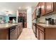 Open kitchen with granite countertops, tile backsplash, and stainless steel appliances at 10036 Crested Fringe Dr, Riverview, FL 33578