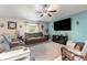 Comfortable living room with plush seating, ceiling fan, and a large flat screen TV at 10036 Crested Fringe Dr, Riverview, FL 33578
