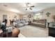 Spacious living area with comfortable seating, neutral tones, and abundant natural light from the windows at 10036 Crested Fringe Dr, Riverview, FL 33578