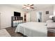 Spacious main bedroom features a ceiling fan, wood-look floors, and neutral walls at 10036 Crested Fringe Dr, Riverview, FL 33578