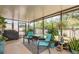 Screened patio featuring comfortable seating, stylish rug, and various potted plants and a grill at 10036 Crested Fringe Dr, Riverview, FL 33578