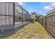 Side yard view with the lattice-skirted deck and screened-in pool at 1017 Hamilton Ave, Tarpon Springs, FL 34689