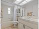 Clean and bright bathroom with a combined tub and shower, and a skylight at 1017 Hamilton Ave, Tarpon Springs, FL 34689