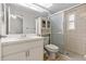 Well-lit bathroom with a shower, vanity, and updated fixtures and modern finishes at 1017 Hamilton Ave, Tarpon Springs, FL 34689