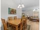 Cozy dining area with wood table, six chairs, and natural light at 1017 Hamilton Ave, Tarpon Springs, FL 34689