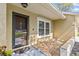 Close-up featuring the front door, decorative rock garden, and exterior details at 1017 Hamilton Ave, Tarpon Springs, FL 34689