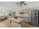 Spacious kitchen featuring an island, stainless steel appliances, and wood-look flooring at 1017 Hamilton Ave, Tarpon Springs, FL 34689