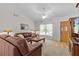 Cozy living room with hardwood floors, a ceiling fan, and natural light streaming through the window at 1017 Hamilton Ave, Tarpon Springs, FL 34689