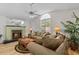 Inviting living room with fireplace, large windows, and comfortable seating at 1017 Hamilton Ave, Tarpon Springs, FL 34689