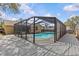 A lovely screened-in pool and deck provide the perfect oasis in this backyard setting at 1017 Hamilton Ave, Tarpon Springs, FL 34689