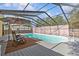 Inviting outdoor pool area with lounge chairs and a screened enclosure at 1017 Hamilton Ave, Tarpon Springs, FL 34689