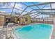 Enjoy this sparkling screened-in pool with ample deck space and lounge chairs, perfect for outdoor relaxation at 1017 Hamilton Ave, Tarpon Springs, FL 34689