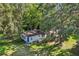 Aerial view of the home surrounded by lush, mature trees on a sprawling green lot at 10565 Bessemer St, New Port Richey, FL 34654