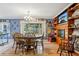Cozy dining room boasts a charming chandelier, fireplace, and custom wooden shelving at 10565 Bessemer St, New Port Richey, FL 34654