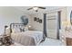 This bedroom features a large bed, a moon mural, and a ceiling fan at 10613 Dusty Boot Rd, Land O Lakes, FL 34638