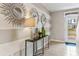 Welcoming entryway with gray striped accent wall, stylish decor, and tiled floors at 10613 Dusty Boot Rd, Land O Lakes, FL 34638