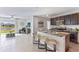 Open concept kitchen with granite countertops, stainless steel appliances, and an eat-in island at 10613 Dusty Boot Rd, Land O Lakes, FL 34638