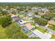 Beautiful community aerial view featuring tree lined streets, houses, and neighborhood pools at 1101 Mclean St, Dunedin, FL 34698