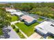 A beautiful aerial view of a home featuring a spacious yard, sidewalk and driveway at 1101 Mclean St, Dunedin, FL 34698