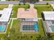 Aerial view of the home showing the roof, fenced yard, and enclosed pool at 1101 Mclean St, Dunedin, FL 34698