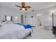 Spacious bedroom with tile floors, open ensuite bathroom, and a white dresser and decor at 1101 Mclean St, Dunedin, FL 34698