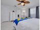 Bedroom featuring tile floors, white dresser and closet, with an open ensuite bathroom at 1101 Mclean St, Dunedin, FL 34698