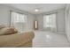 Bright bedroom featuring tile flooring, large windows, and a comfortable seating area at 1101 Mclean St, Dunedin, FL 34698