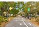 Picturesque Dunedin bike path entrance marked with railway crossing style welcome sign and lush green trees overhead at 1101 Mclean St, Dunedin, FL 34698
