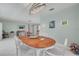 Elegant dining room with a chandelier, wooden table, and a view into the adjacent living room at 1101 Mclean St, Dunedin, FL 34698