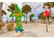 Green dolphin statue with sea life decorations in a landscaped park on the waterfront at 1101 Mclean St, Dunedin, FL 34698