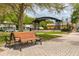Charming park view showcasing a central gazebo and a traditional wood and iron park bench in the foreground at 1101 Mclean St, Dunedin, FL 34698