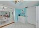 Bright tiled kitchen with white cabinets, shelving, and a small breakfast bar at 1101 Mclean St, Dunedin, FL 34698