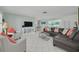Spacious living room with tile floors, comfortable seating, and a view into the dining area at 1101 Mclean St, Dunedin, FL 34698