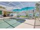 Screened-in pool area with ample patio and lounge seating with a covered patio nearby at 1101 Mclean St, Dunedin, FL 34698